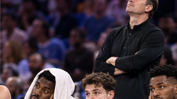 Satirical editorial image of a dejected basketball bench during a one-sided game.