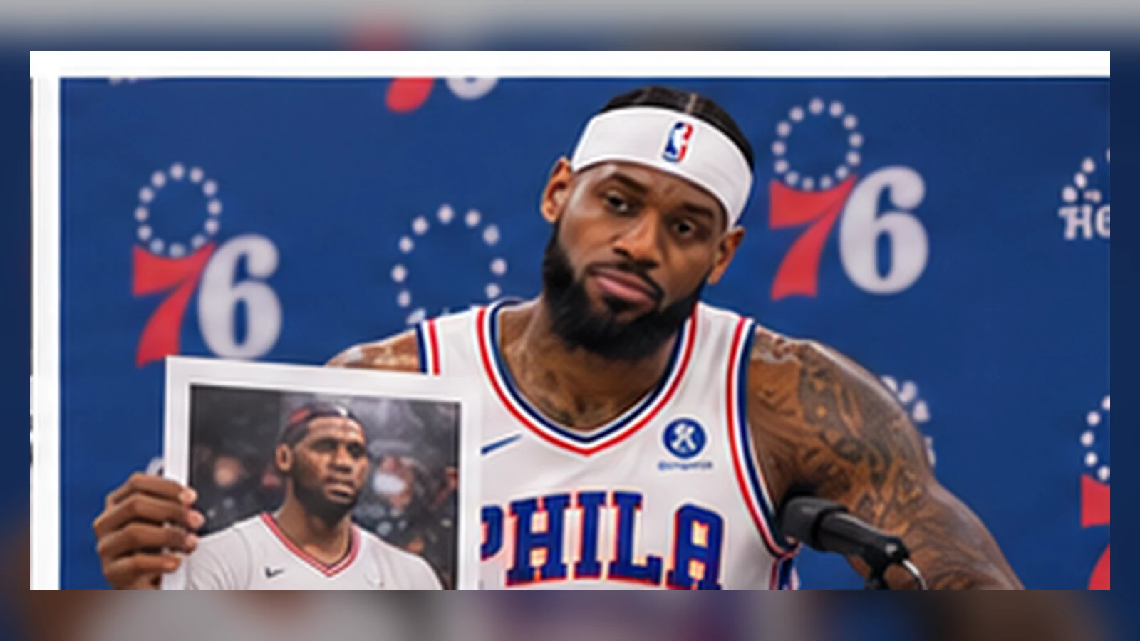 LeBron James in current Philadelphia 76ers blue No. 23 gear examines his 2003 rookie file in a satirical NBA archive room.